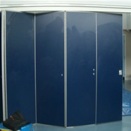 Blue movable partition panels partly folded open in a plain room.